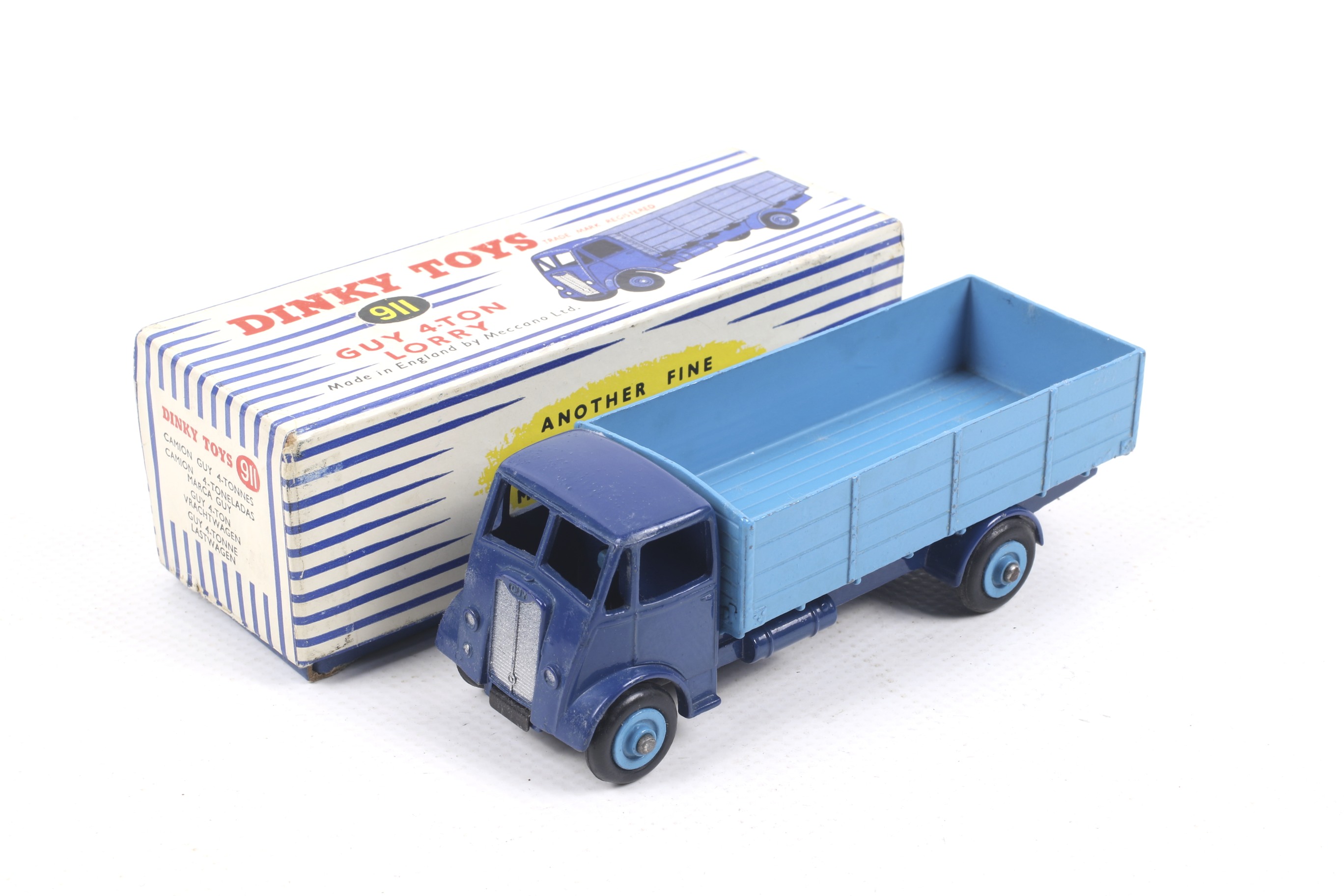 A Dinky diecast Guy 4-Ton Lorry. No. 911 dark blue lorry with light blue bed, in original box.