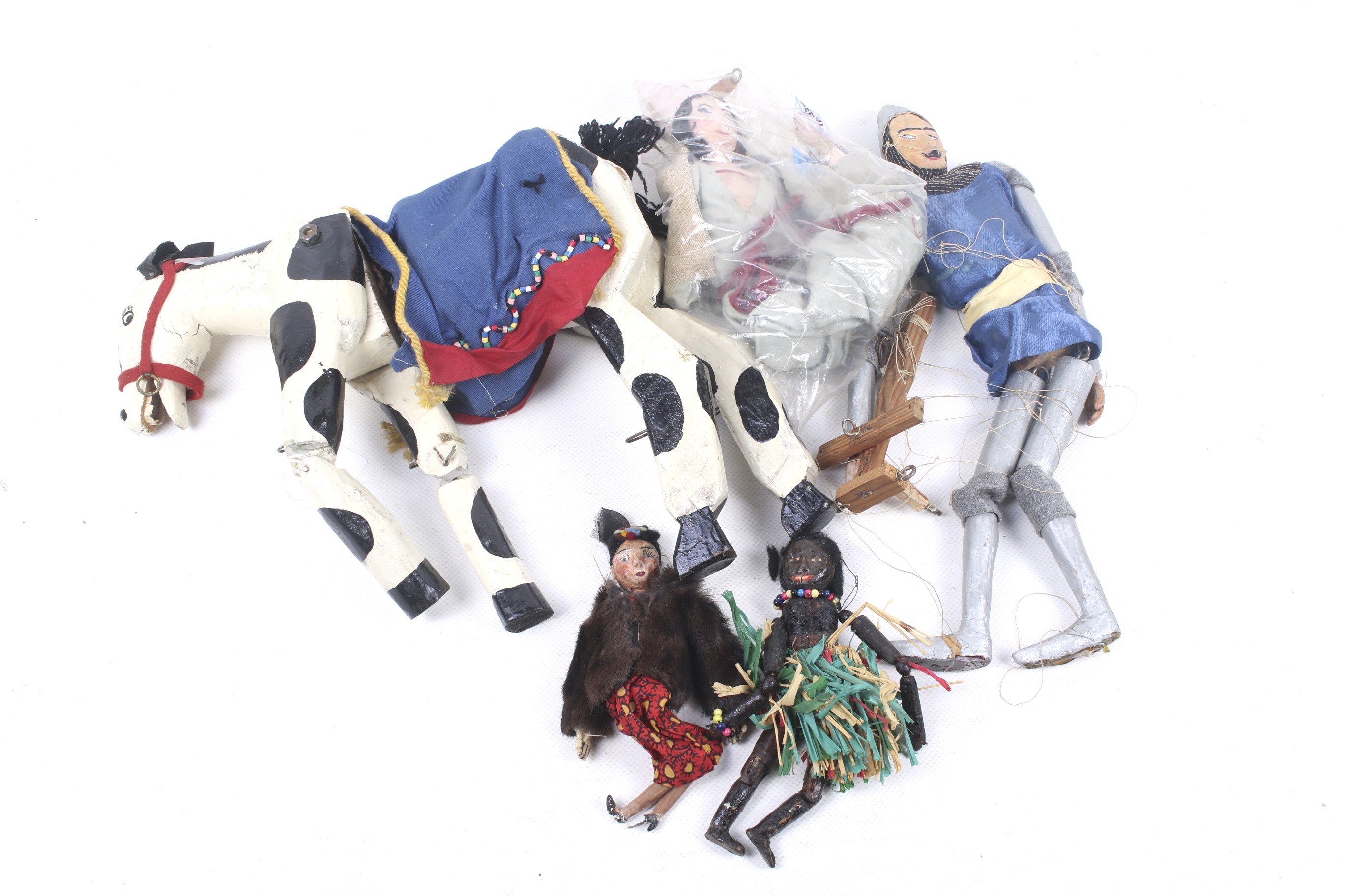 A collection of five hand made wooden puppets.