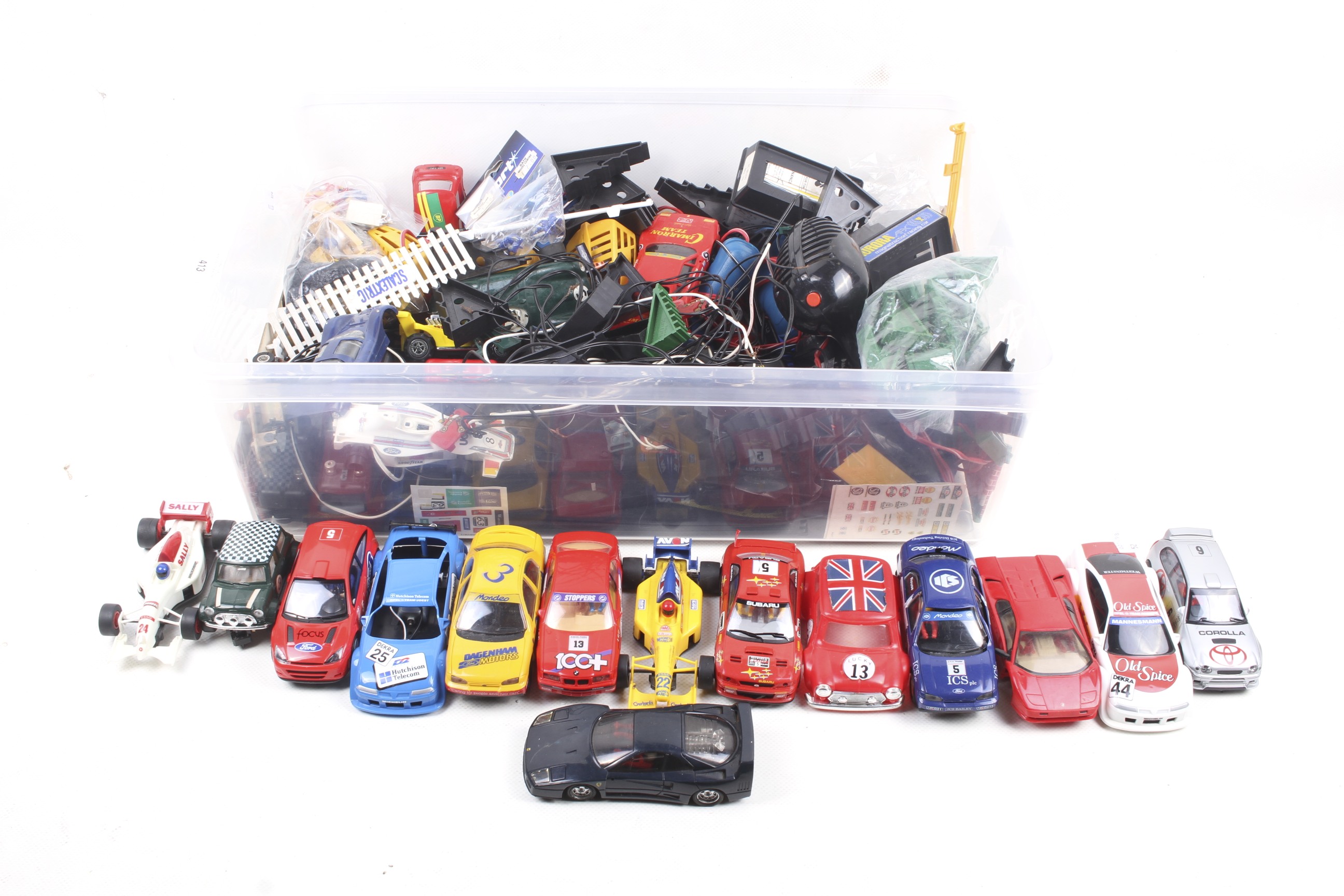 An assortment of slot car racing cars and accessories.
