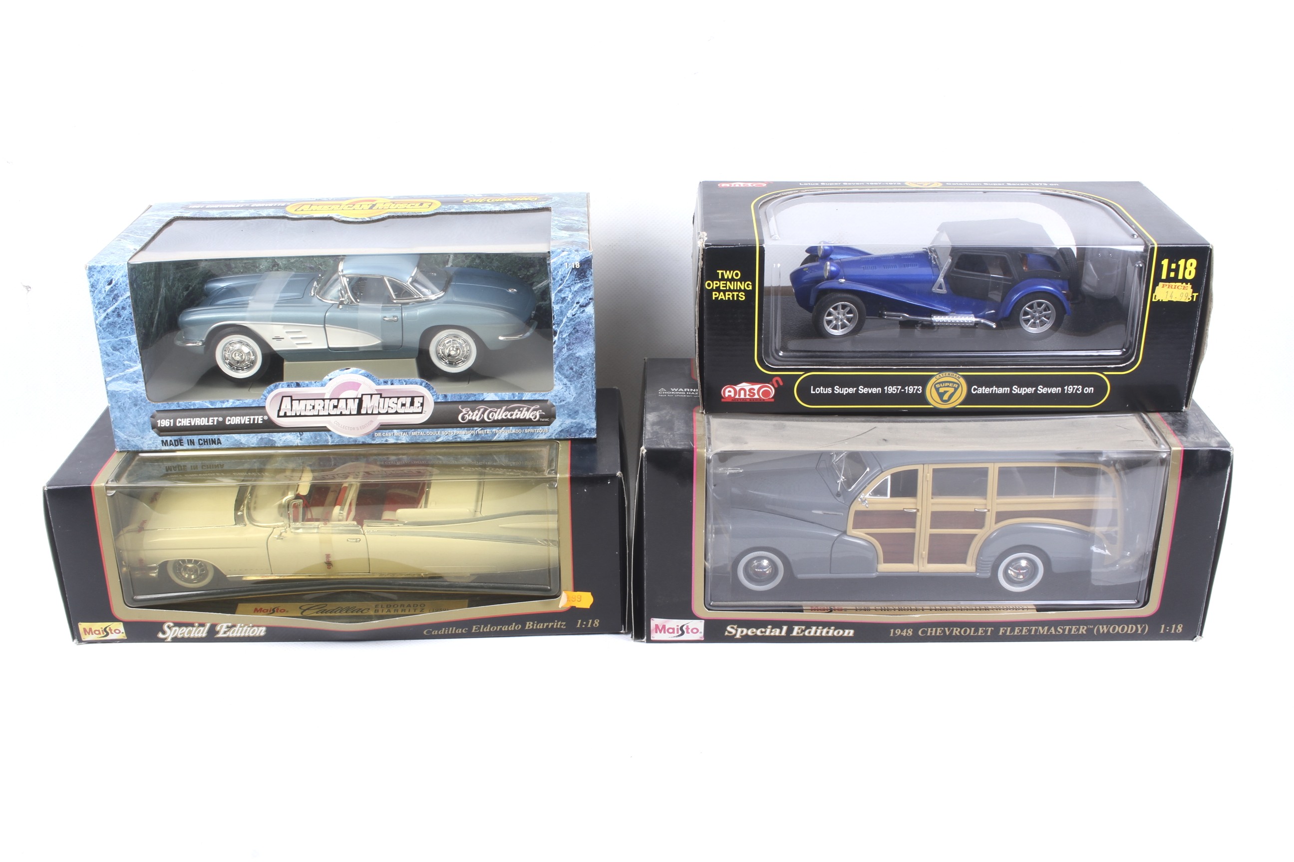 Four 1:18 scale diecast cars.