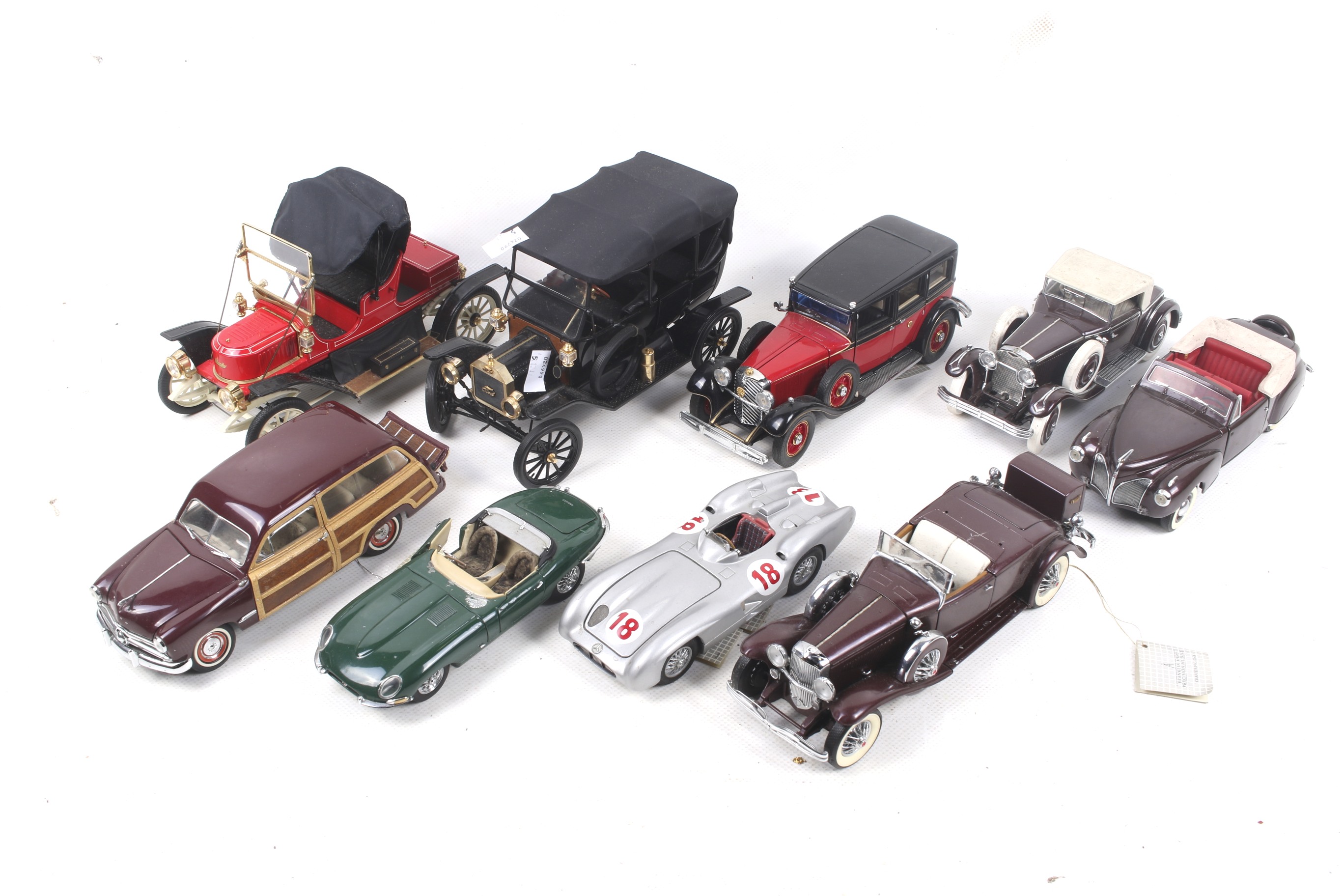 A collection of nine 1:24 scale Franklin Mint diecast cars.
