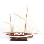 A wooden model of an American Schooner on stand.