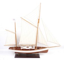 A wooden model of an American Schooner on stand.