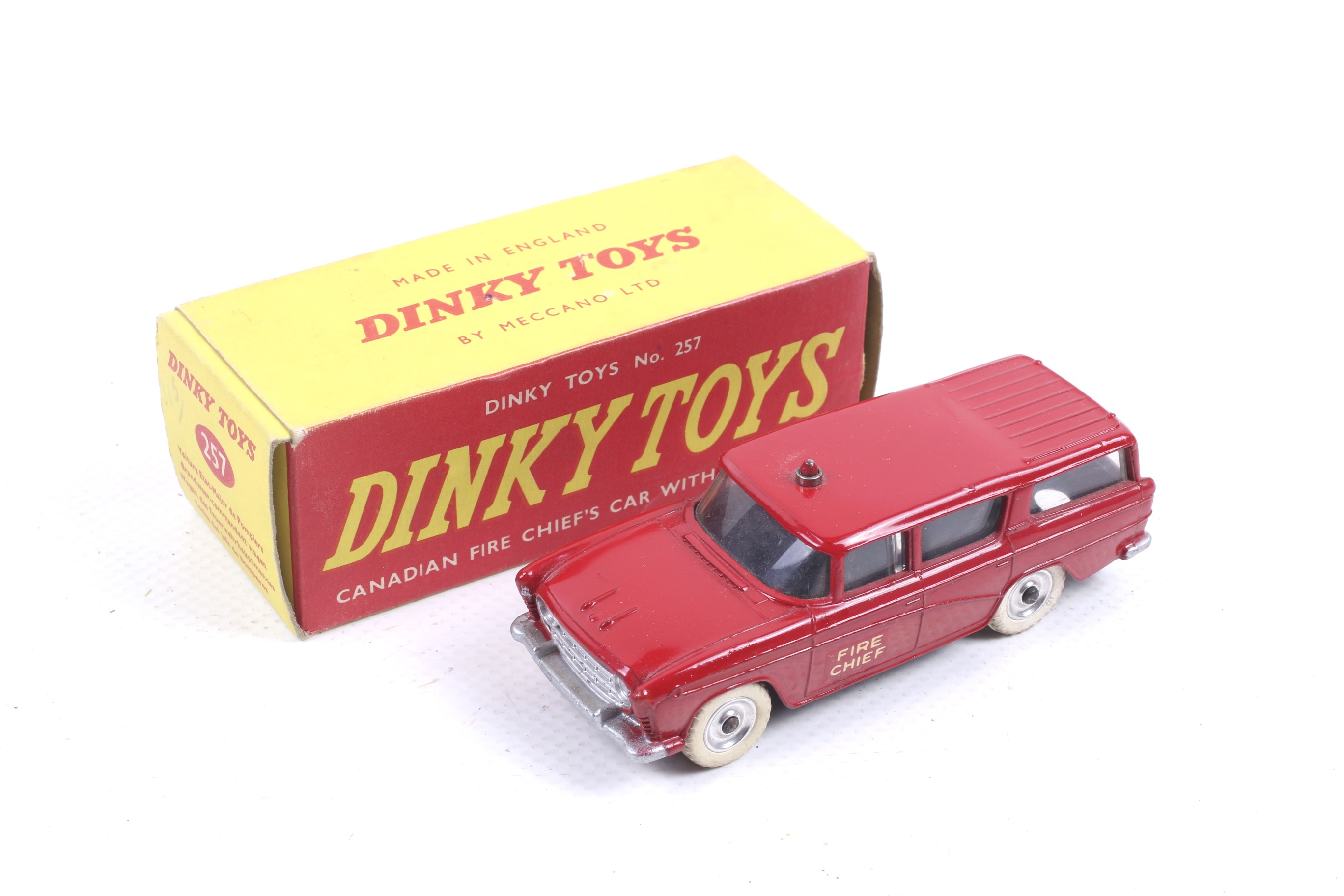 A Dinky diecast Canadian Fire Chiefs Car. No. 257, red body with white wheels, in original box.