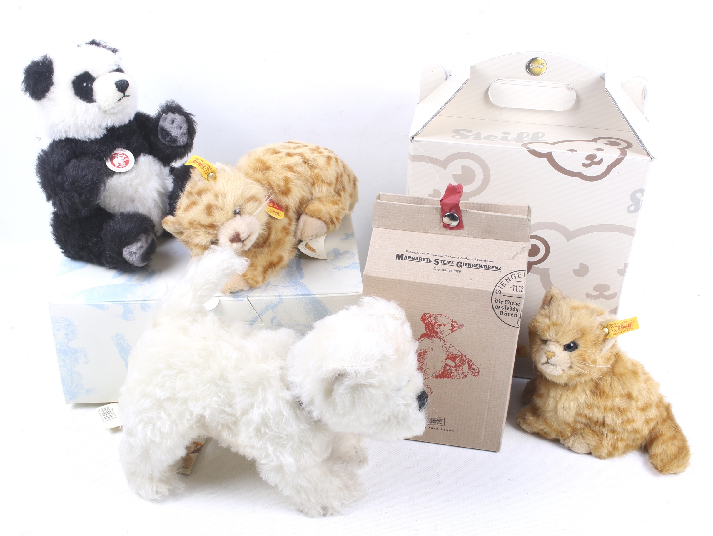 A collection of four Steiff animal teddy bears.