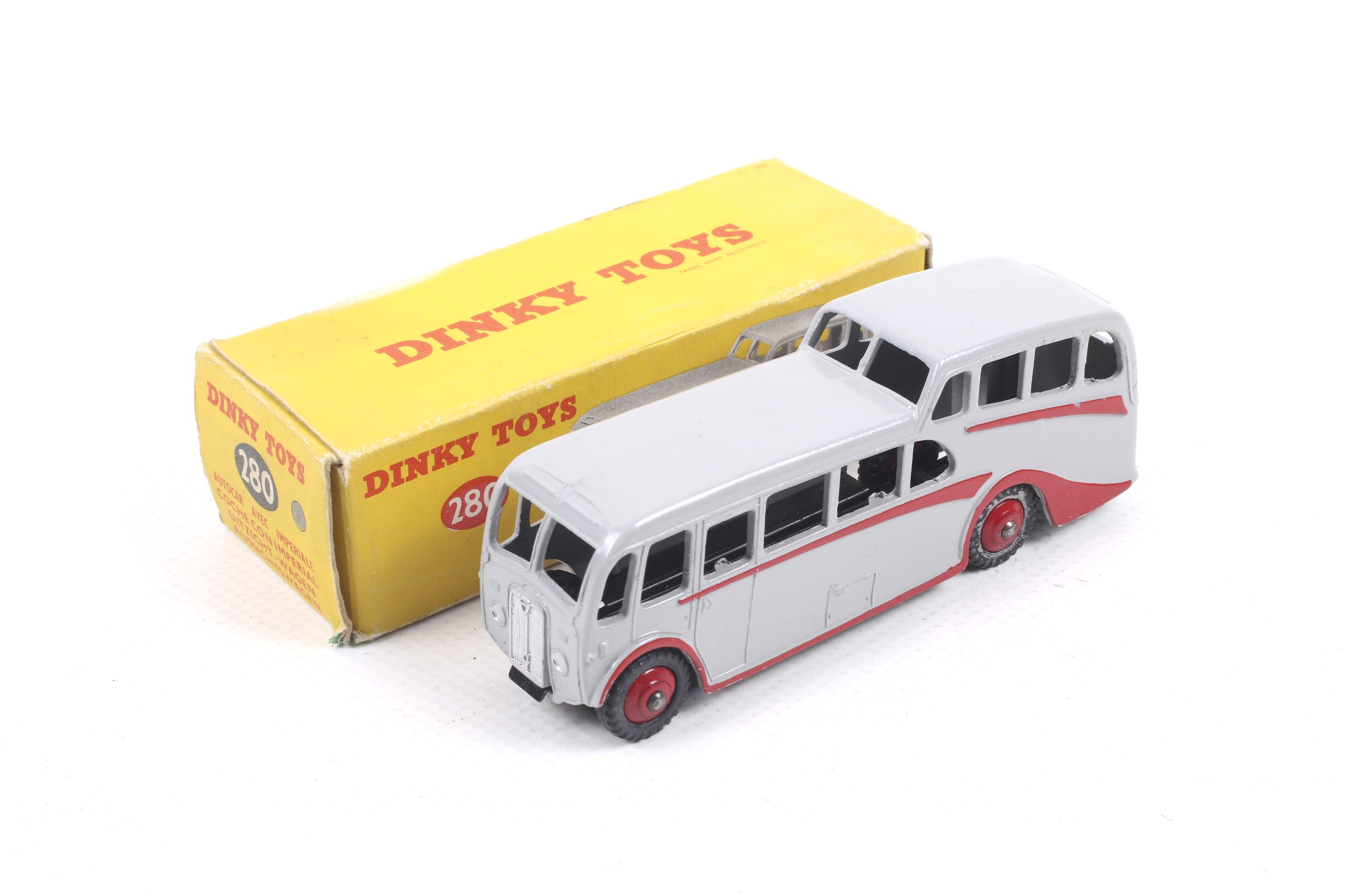 A Dinky diecast Observation Coach. No. 280, grey body with red trim and wheels, in original box.