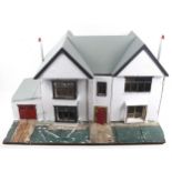 A vintage scratch built dolls house and contents.