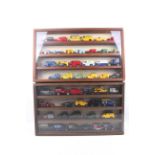 A collection of mainly diecast vans in two wooden display cabinets.