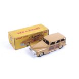 A Dinky diecast Estate Car. No. 344, with a tan and brown body with white wheels, in original box.