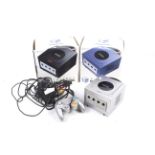 Three Nintendo Gamecube consoles. Complete with controllers etc, two boxed, one unboxed.