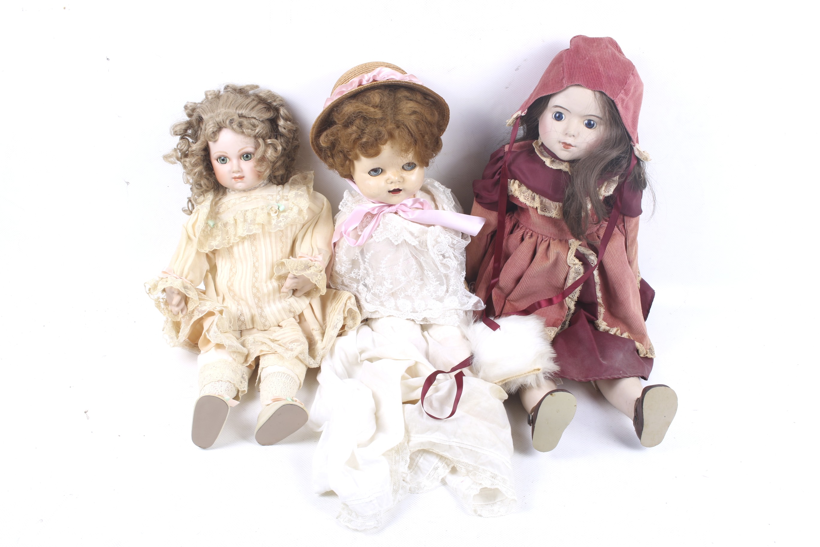 A collection of three dolls. In a range of outfits and head wear etc.