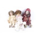 A collection of three dolls. In a range of outfits and head wear etc.