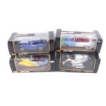 Four 1:18 scale diecast cars.