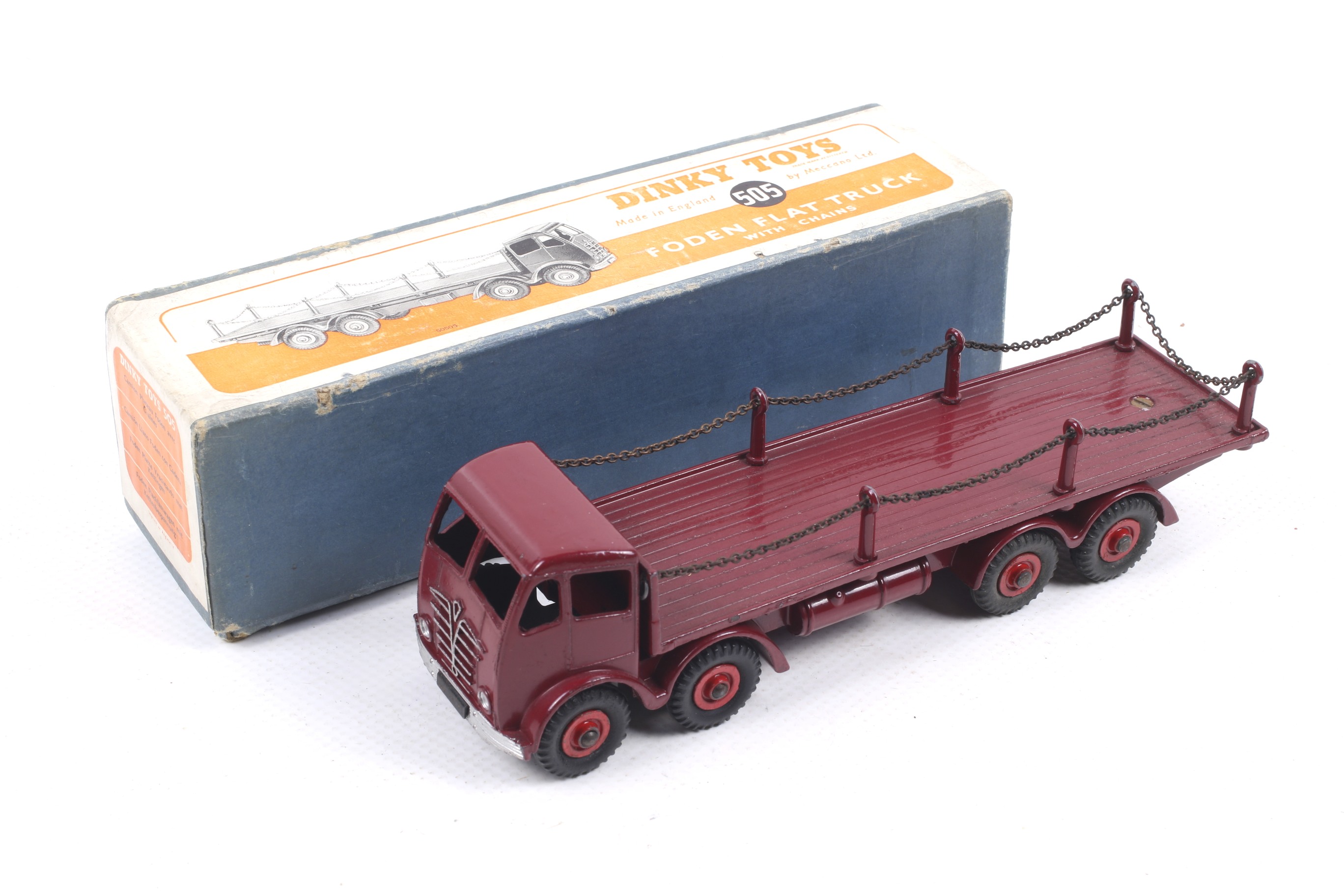 A Dinky diecast Foden Flat Truck. No. 505, red body and wheels with chain, in original box.