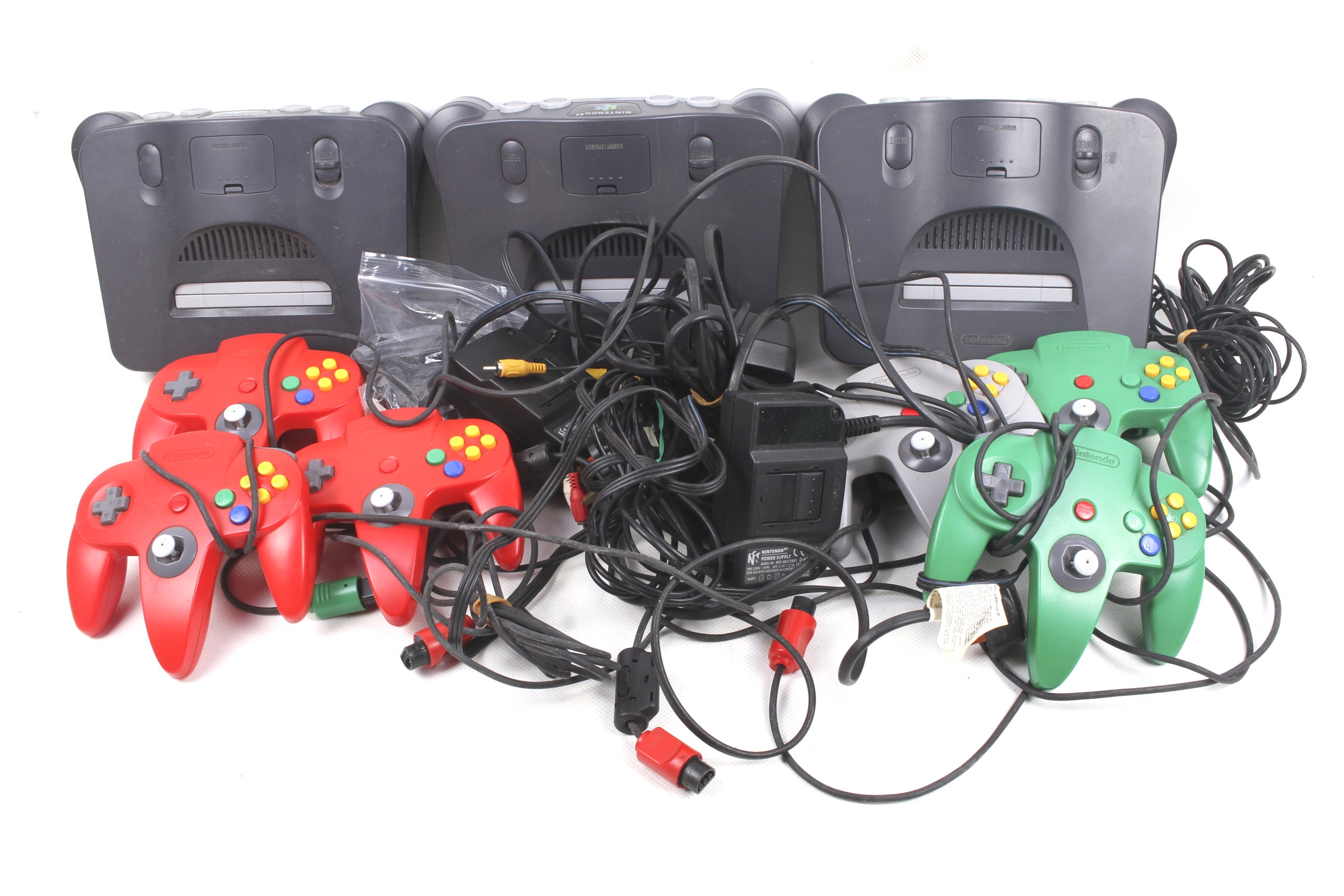 Three Nintendo 64 consoles and accessories.