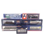 Seven mainly Bachmann OO gauge goods wagons and coaches.