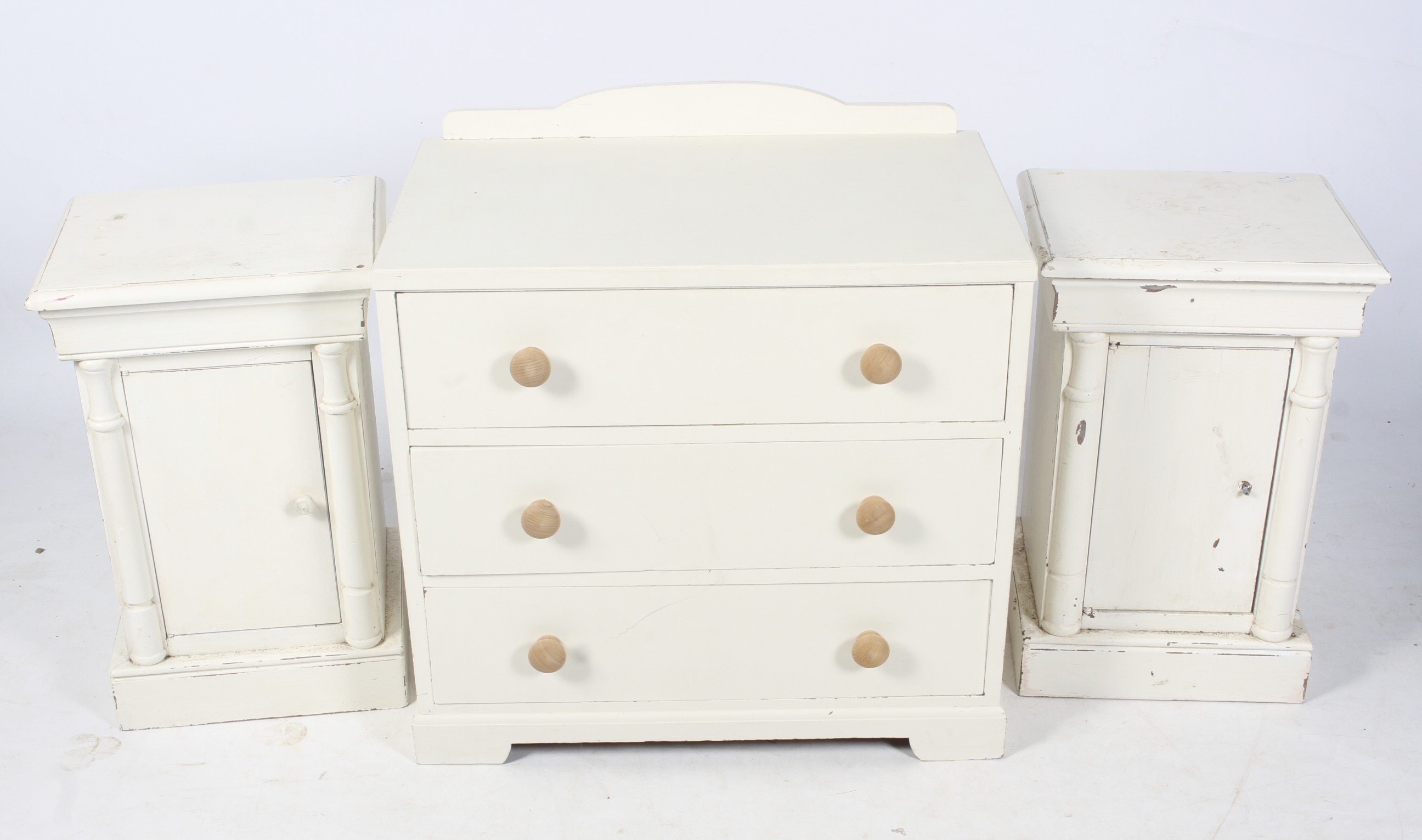 A vintage chest of drawers and a pair of bedside tables.