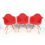 A set of three Charles and Ray Eames for Vitra armchairs.