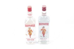Two bottles of Beefeater gin. one bottle contains 1l, 40% vol, the second 1.14l, 47% vol.