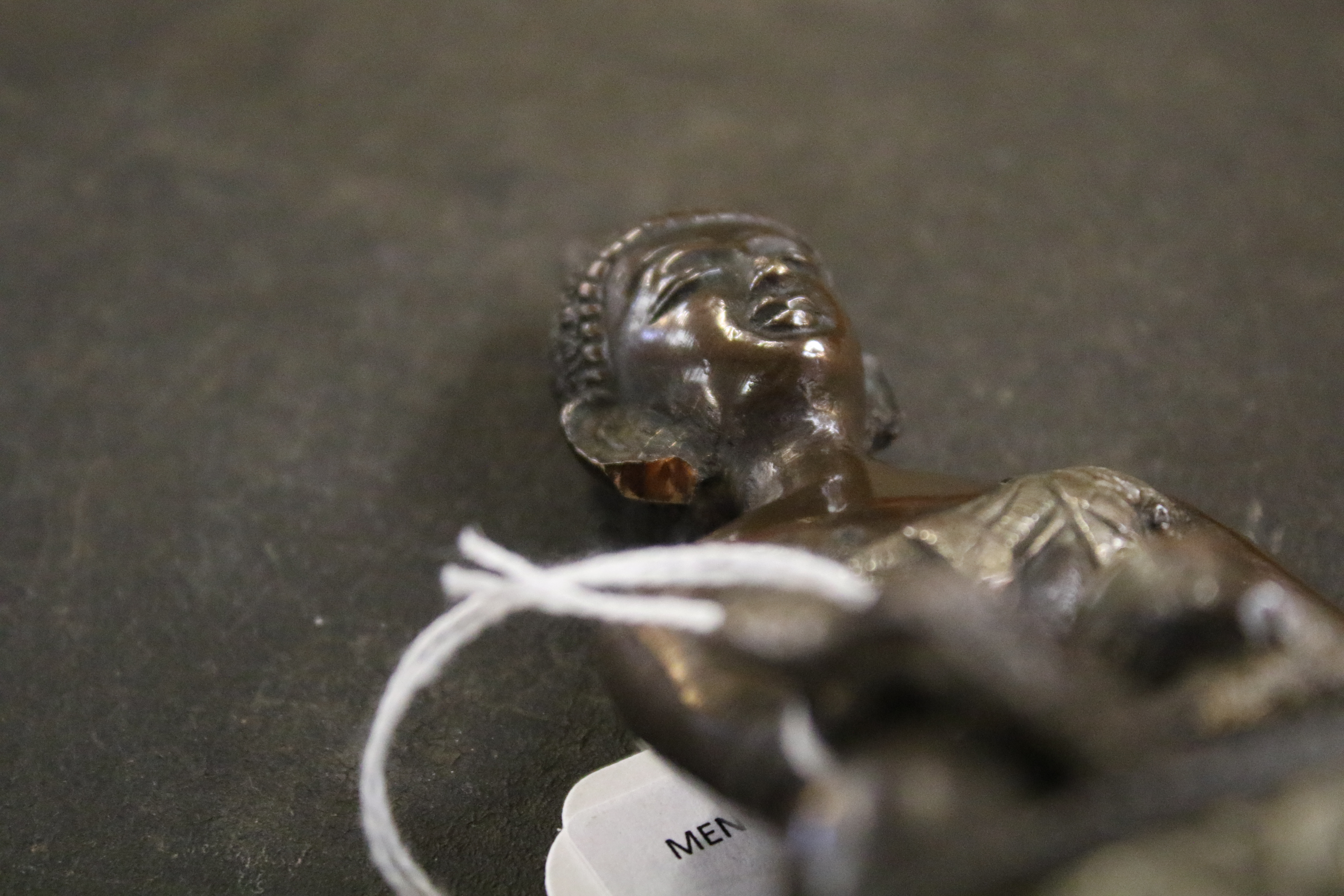 A Tibetan bronze figure of Buddha Shakyamuni with white metal inlay. - Image 7 of 8
