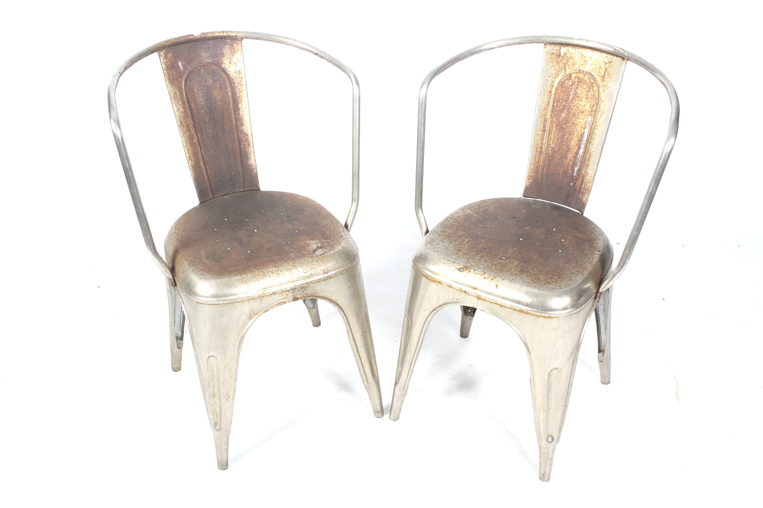 A pair of metal 'Industrial' style chairs. Curved back, on tapered supports.