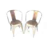 A pair of metal 'Industrial' style chairs. Curved back, on tapered supports.