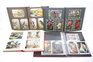 Four albums of assorted vintage and modern postcards.