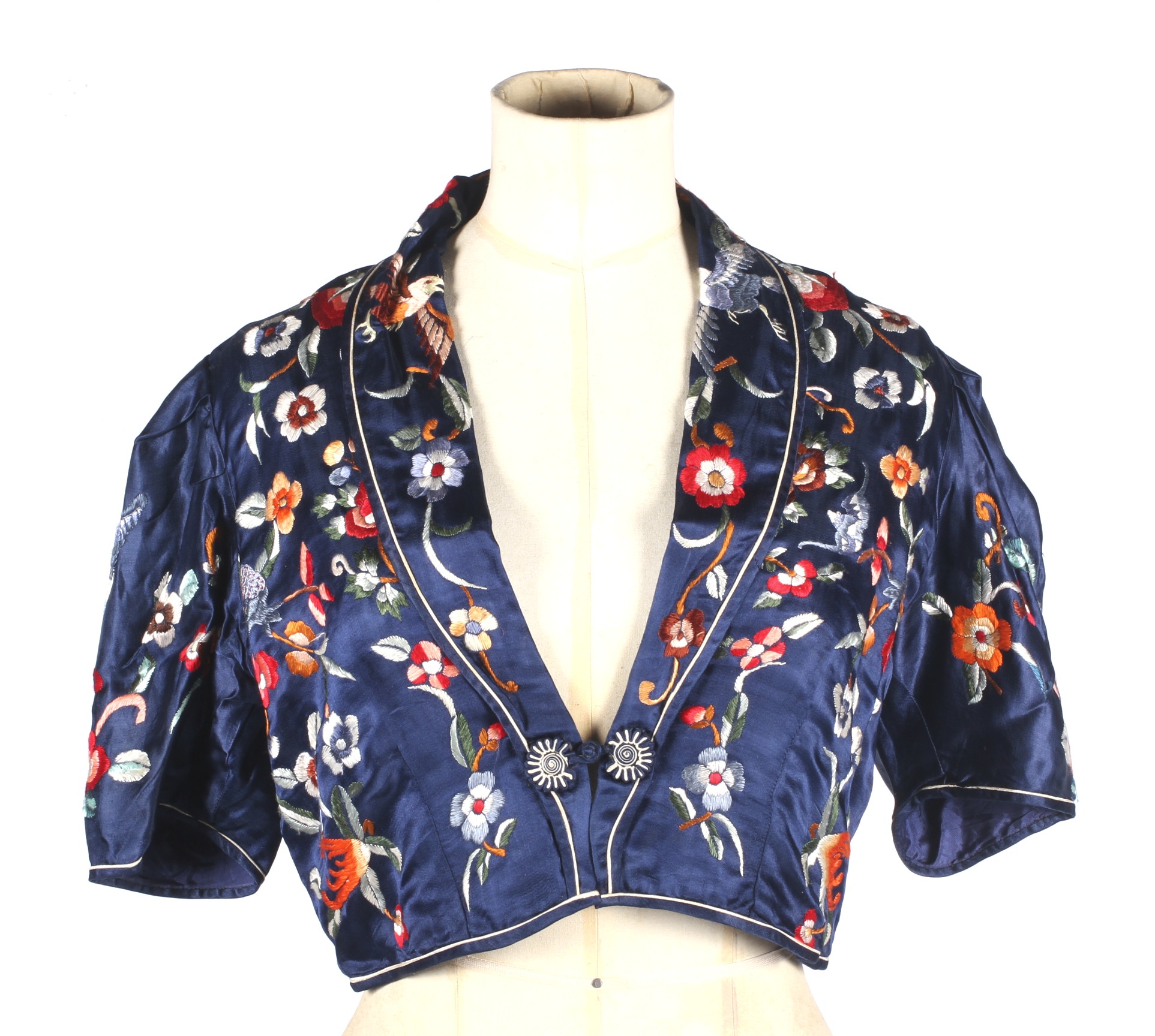 A 20th century Asian hand stitched bolero. With short sleeves, a long collard and single fastening.