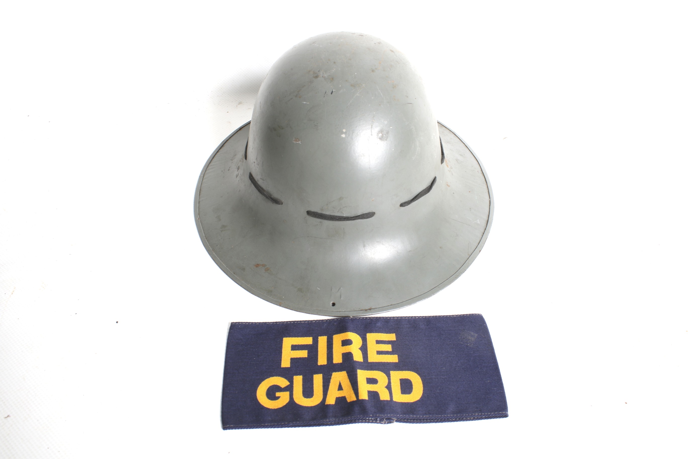 A WWII home front 'Zuckerman' helmet and a 'Fire Guard' armband.