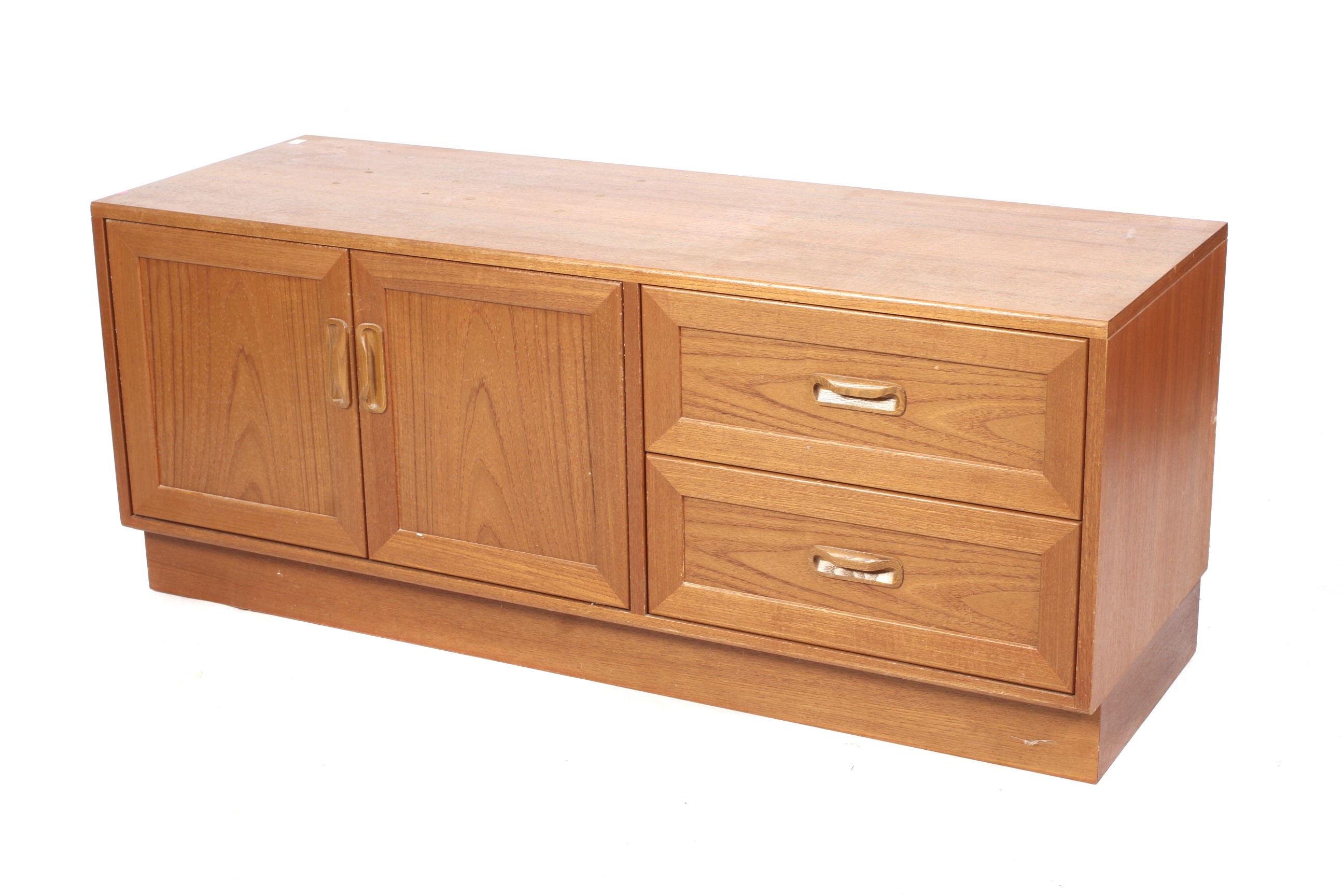 A low teak G Plan sideboard. With two drawers and double doors, with gold on red G Plan label.
