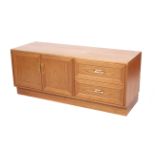 A low teak G Plan sideboard. With two drawers and double doors, with gold on red G Plan label.