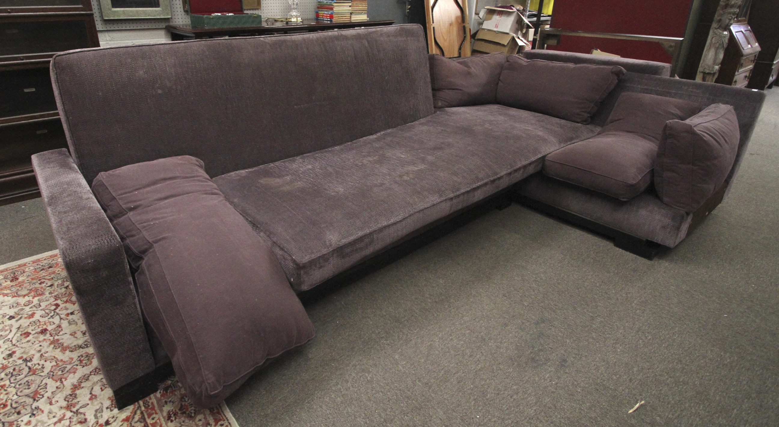 A large contemporary adjustable corner sofa and footstool.