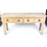 A rustic vintage scrubbed pine sideboard. With two drawers and turned handles on square supports.