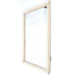 A large rectangular framed wall mirror. Antique style glass with painted moulded frame.