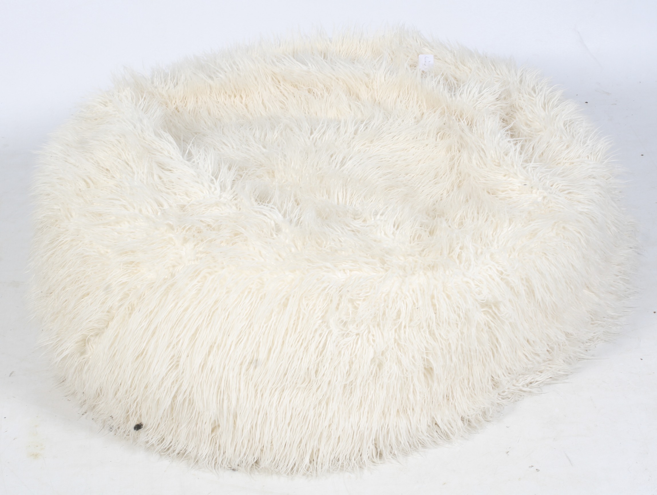 A large faux white sheepskin beanbag.