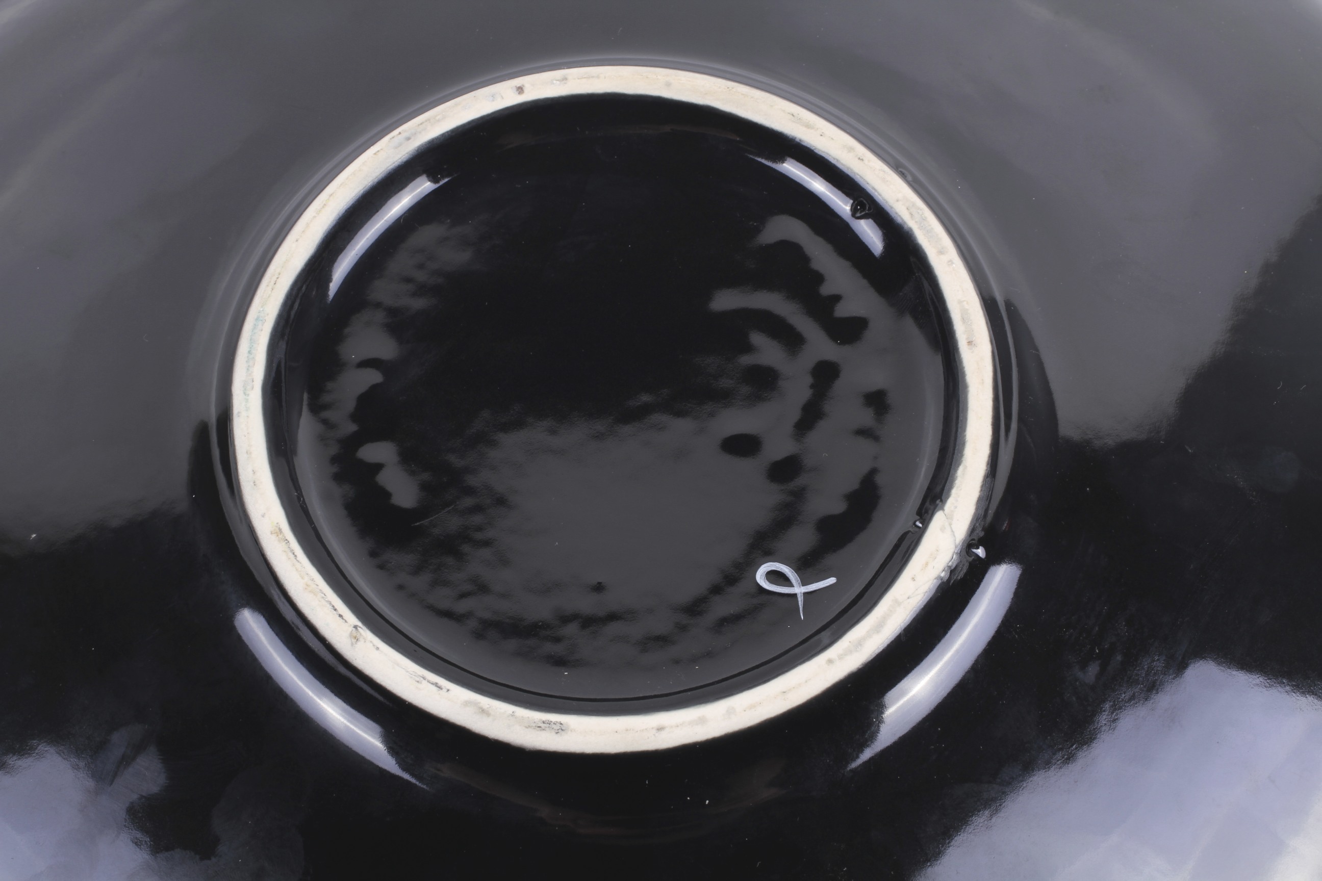 An unmarked Poole Pottery Delphis charger. With black glaze base. - Image 2 of 2