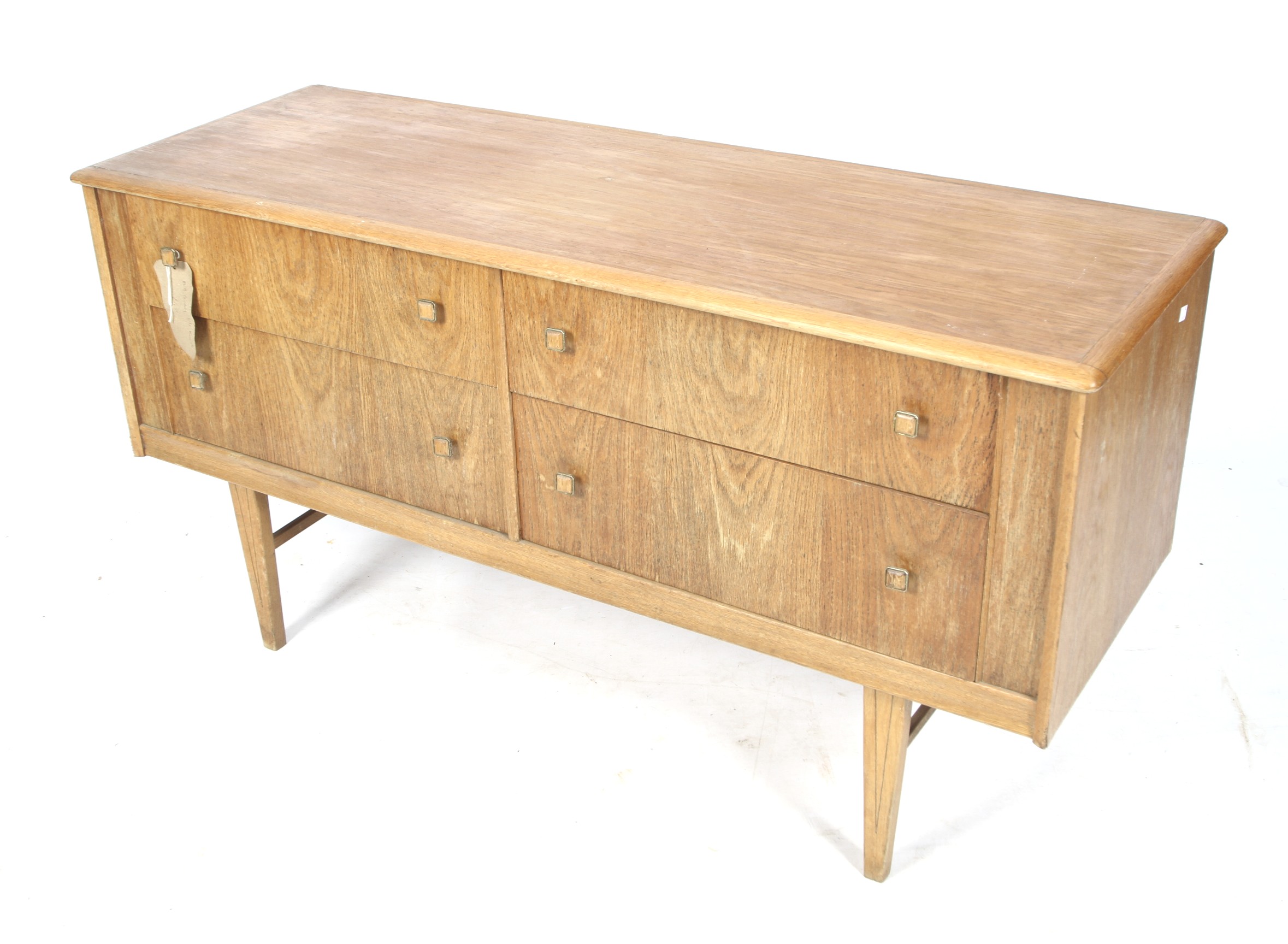 A mid-century oak chest of drawers. Of two drawers over two with tapering square supports.