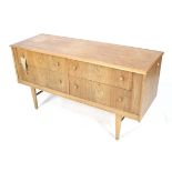 A mid-century oak chest of drawers. Of two drawers over two with tapering square supports.
