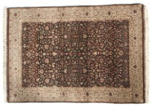 A Persian Tabriz brown ground wool rug with cream decoration.