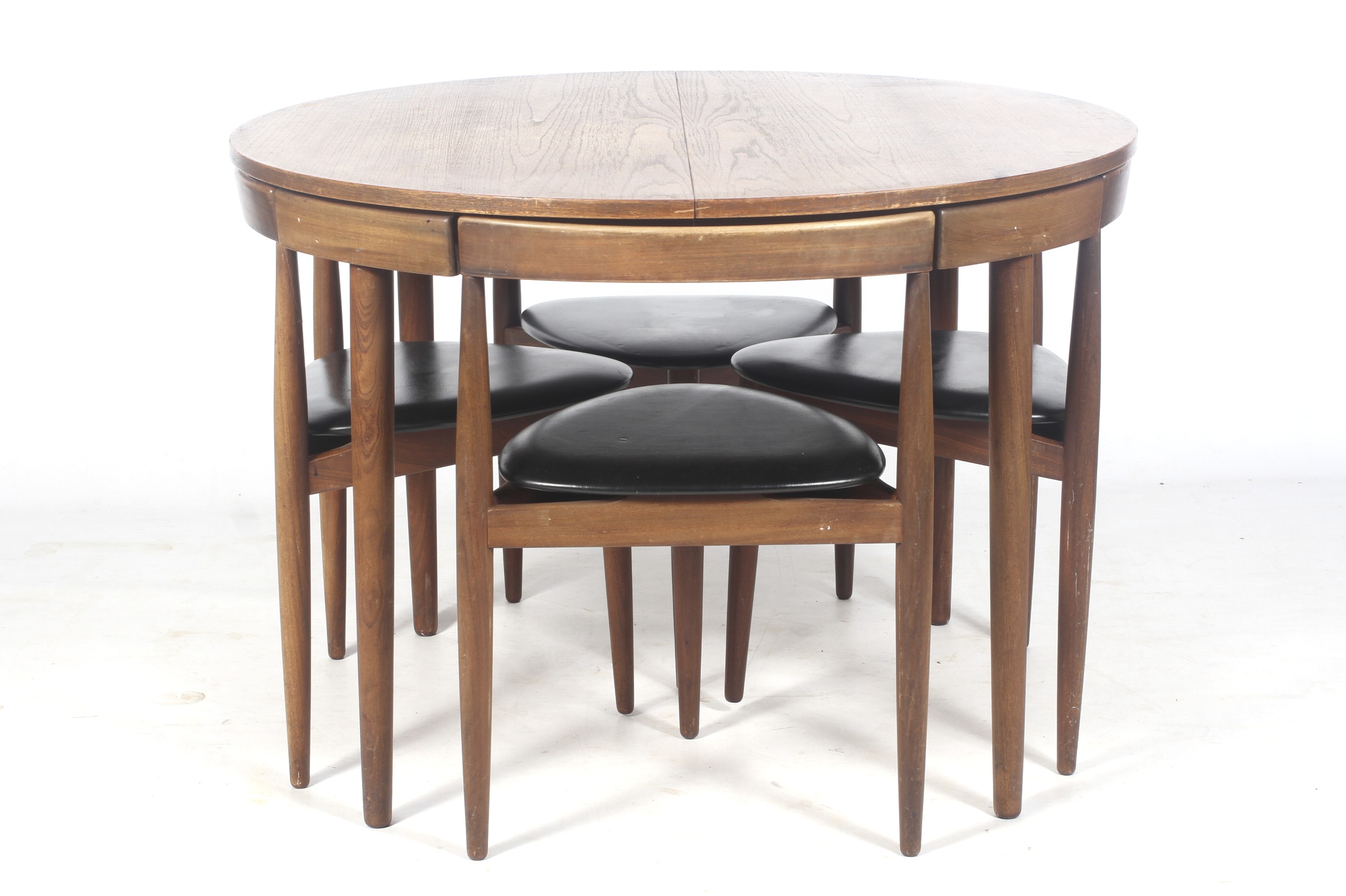 A 1960s Frem Rojle 'Roundette' extending teak table and five chairs by Hans Olsen.