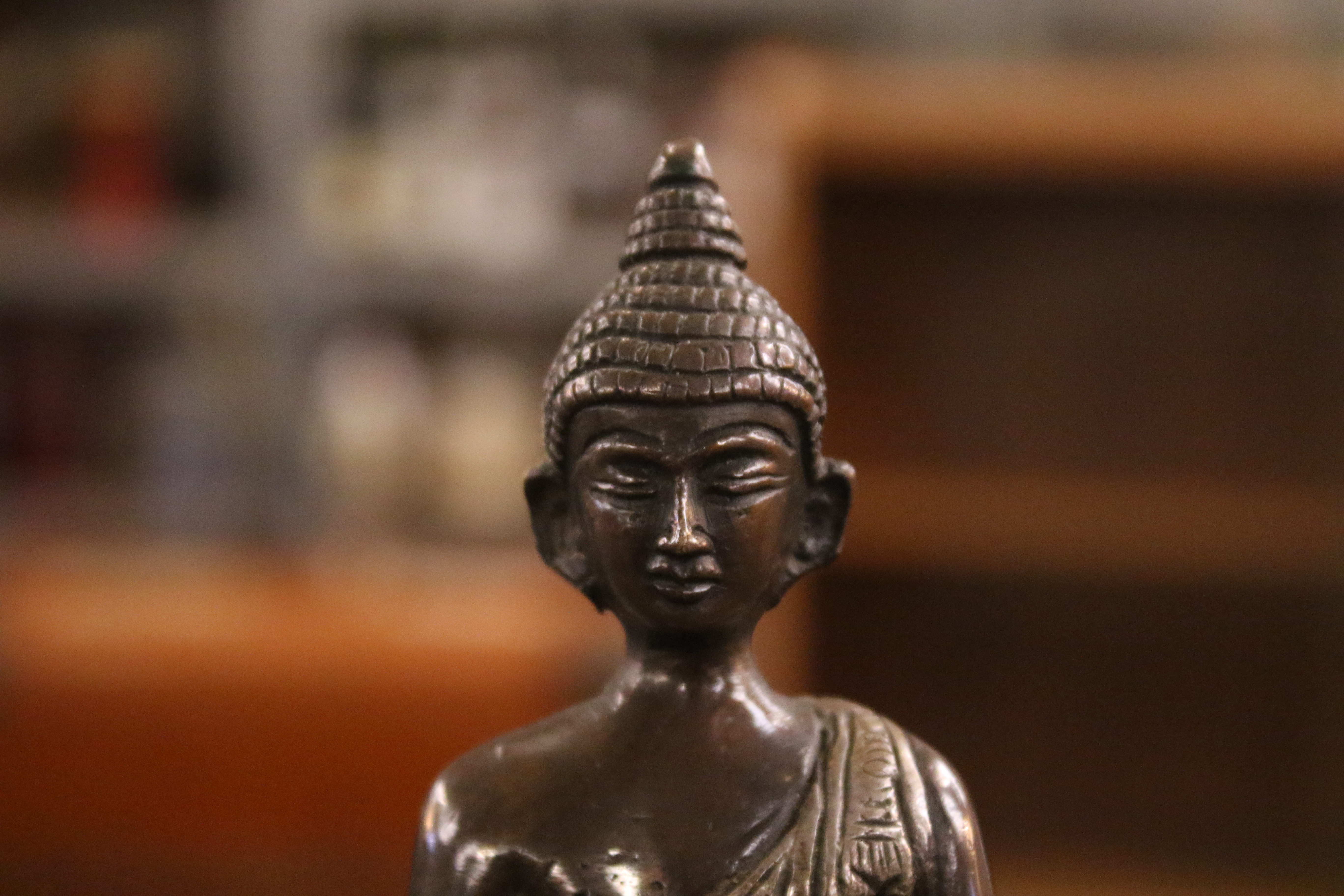 A Tibetan bronze figure of Buddha Shakyamuni with white metal inlay. - Image 8 of 8