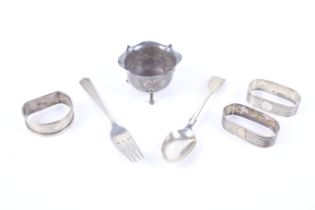 A collection of small silver including a small salt cellar with a shaped border and three feet,