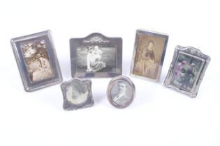 Five small silver mounted photograph frames and another unmarked.