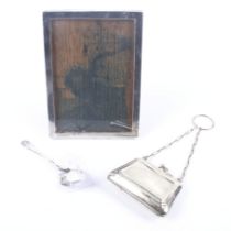 A silver mounted rectangular photograph frame, a jam spoon and an EPNS purse.