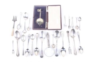 A collection of silver spoons and other items.