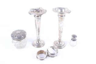 A small collection of silver including a pair of damaged silver trumpet-shaped specimen vases.