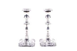 A pair of late Victorian silver candlesticks in George III style.
