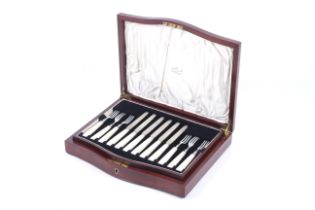 A set of twelve Mappin & Webb silver and mother of pearl handled tea knives and forks.
