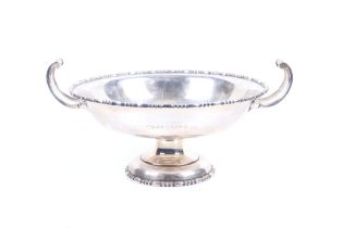A silver two handled cake stand on foot or tazza.