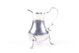 An early George III silver baluster shaped cream jug.